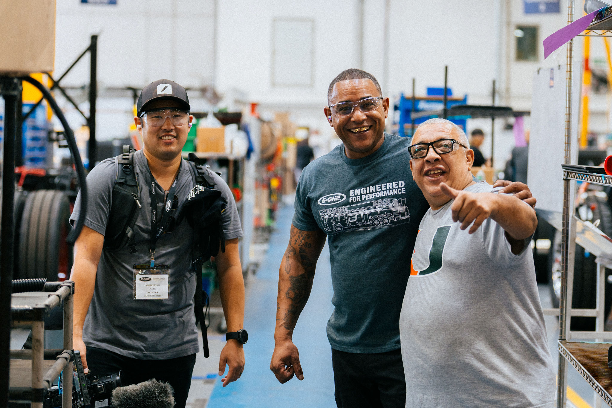 Our content director with E-ONE factory workers mid laugh
