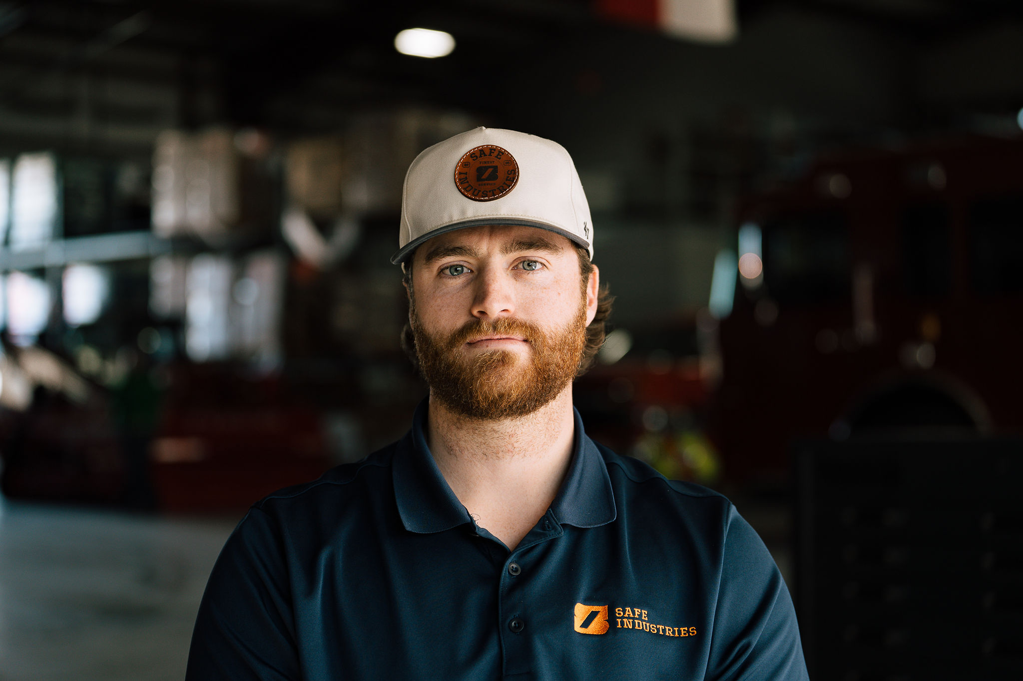 A Safe Industries teammate looking straight into the camera in the warehouse